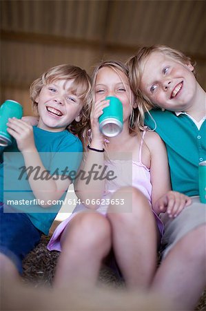 Children drinking soda in garage