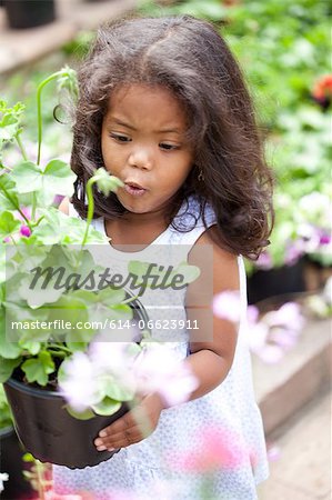Girl carrying potted flowers outdoors