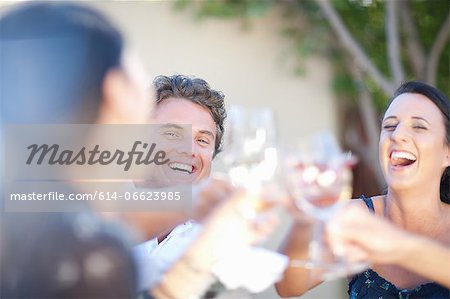 Friends toasting each other outdoors