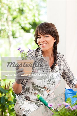 Woman potting plants outdoors