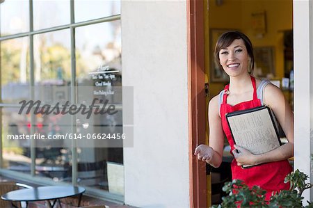 Waitress standing at cafe door