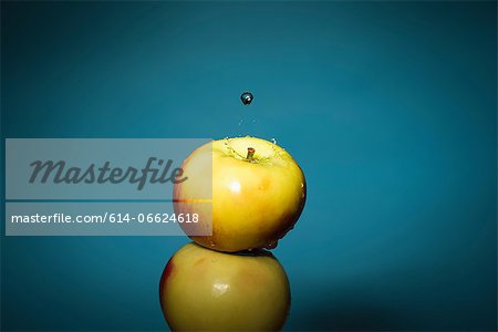 Close up of water splashing on apple Close up of water splashing on apple