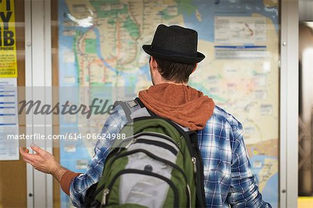Confused man reading city map Confused man reading city map