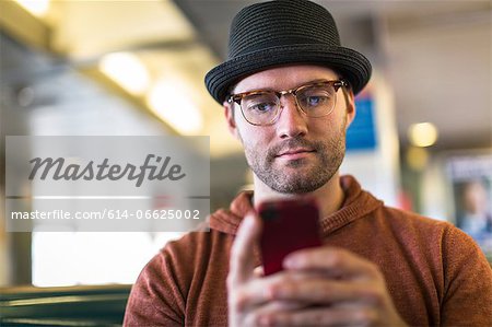 Man using cell phone on bench