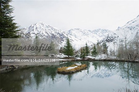 Mountains reflected in still rural lake