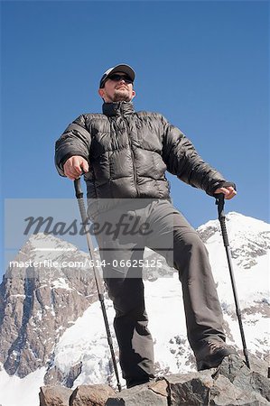 Hiker overlooking snowy mountains