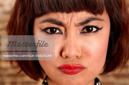 Close up of woman's frowning face