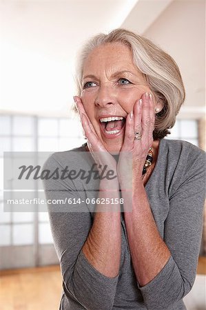 Smiling older woman gasping