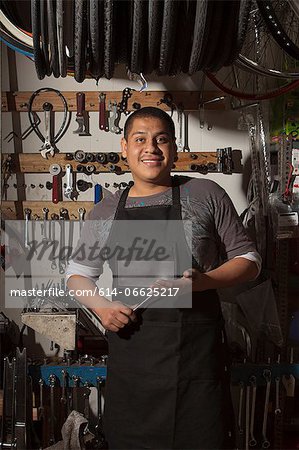 Mechanic smiling in bicycle shop