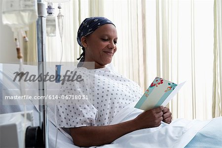 Female hospital patient reading get well card