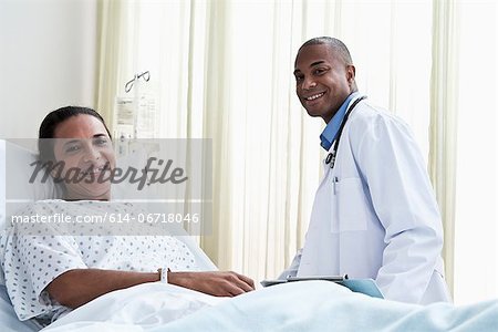 Male doctor and female patient in hospital Male doctor and female patient in hospital