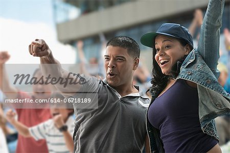 Couple cheering at sports game