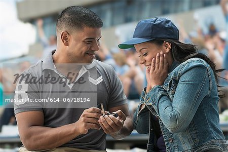 Man proposing to girlfriend at sports game