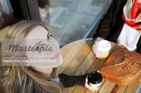 Woman smiling at sidewalk cafe