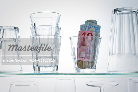 Euro banknotes in glass on shelf