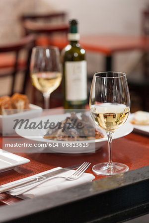 Table set with dish and white wine