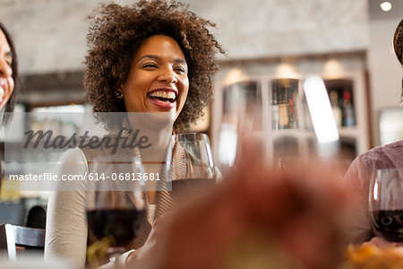 Woman at restaurant laughing