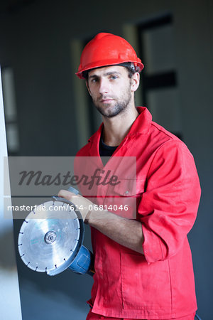 Portrait of building contractor with circular saw