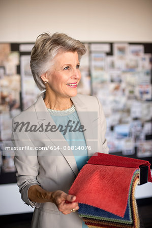 Senior woman holding textile swatch