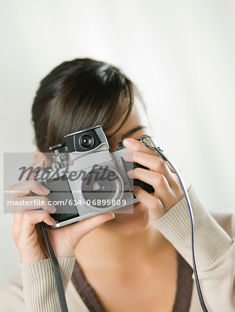 Young woman taking photograph