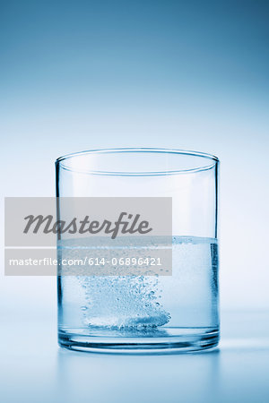 Tablet fizzing in glass of water Tablet fizzing in glass of water