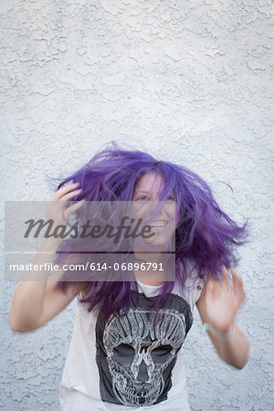Young woman wearing purple wig