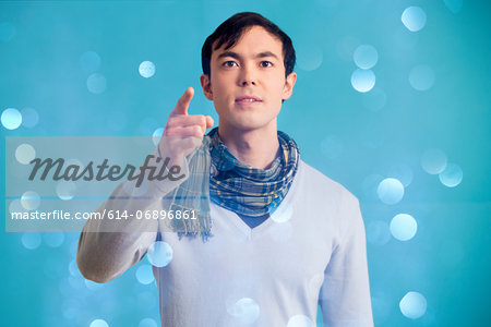 Portrait of young man wearing blue jumper and scarf