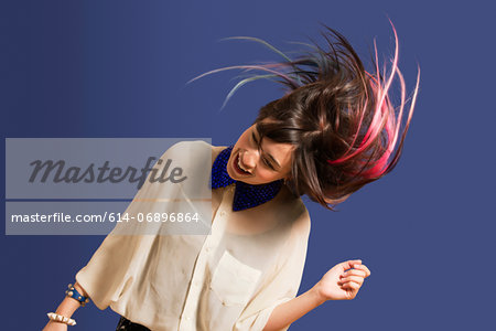 Portrait of young woman with dyed hair dancing