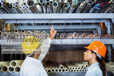 Two warehouse workers in front of shelves Two warehouse workers in front of shelves