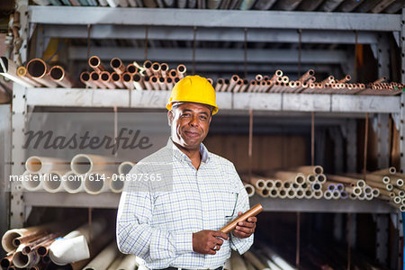 Man in warehouse with copper pipe Man in warehouse with copper pipe