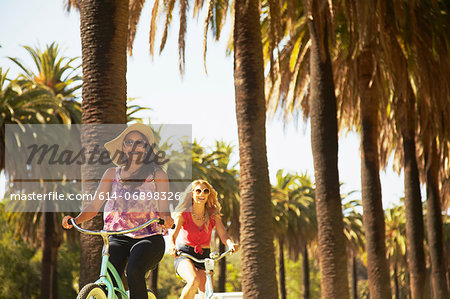 Women on bicycle laughing Women on bicycle laughing