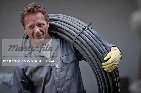Man carrying reel of cable