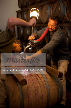 Pumping into barrel of wine