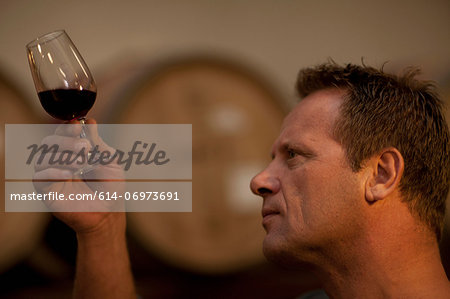 Man checking the color of red wine