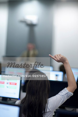 Student with arm raised in lecture