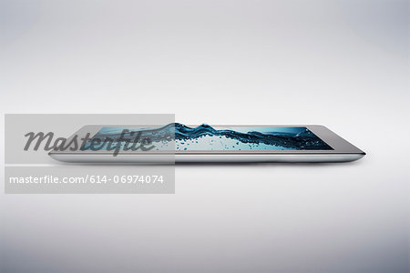 Digital tablet with gently rising bubbling water on screen