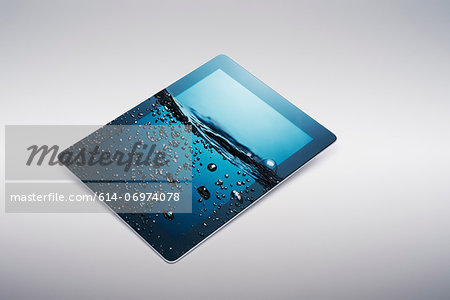 Digital tablet with gently rising bubbling water on screen