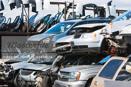 Cars stacked in scrap yard