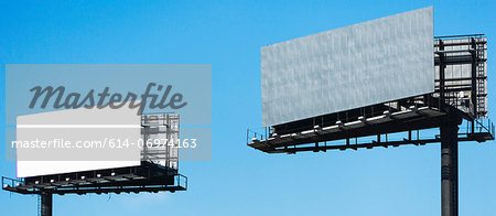 Blank billboards against blue sky