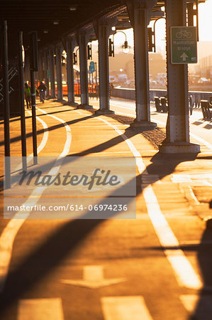 Cycle route below bridge at sunset  New York City, USA