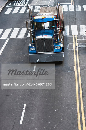 Blue truck driving on city street Blue truck driving on city street