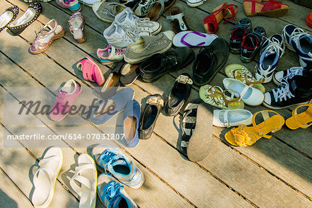 Large group of shoes on wooden planks