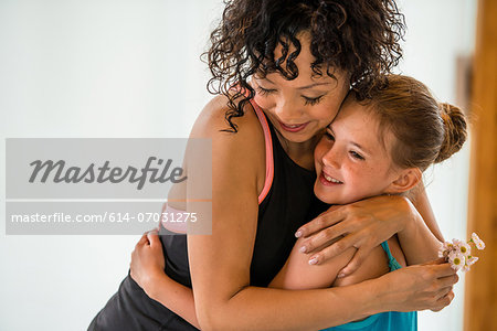 Mature teacher hugging ballerina