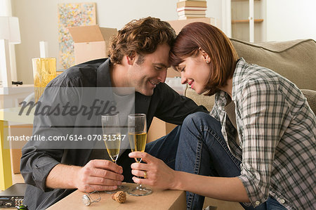 Couple sharing champagne break whilst moving