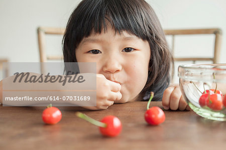 Girl eating cherries, portrait
