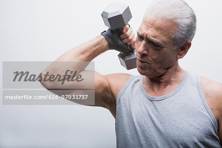 Senior man lifting dumbbell