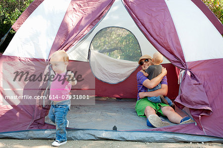 Father and toddler twins in tent