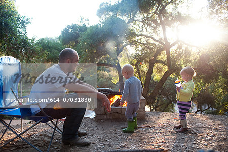 Toddler twins on camping site with father