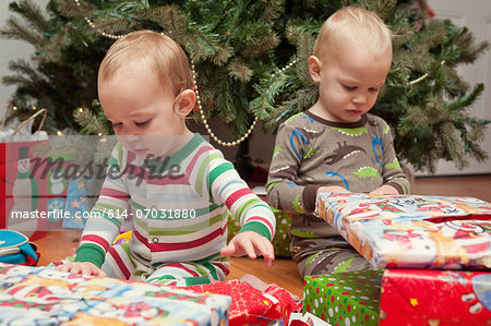 Brother and sister looking at Christmas presents