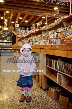Young girl standing in store, portrait